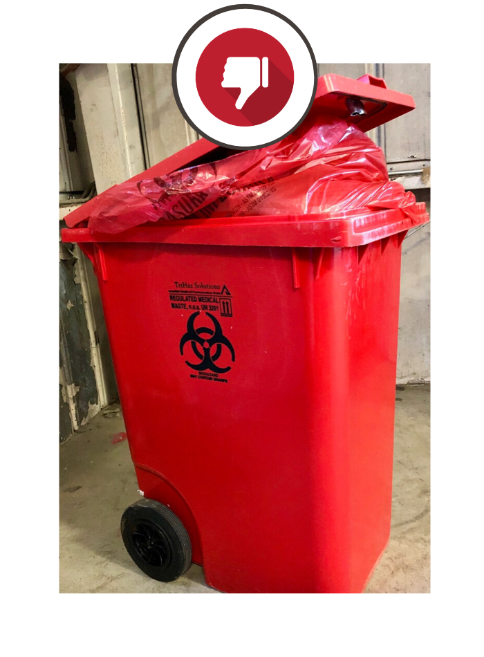 overfilled red medical waste container