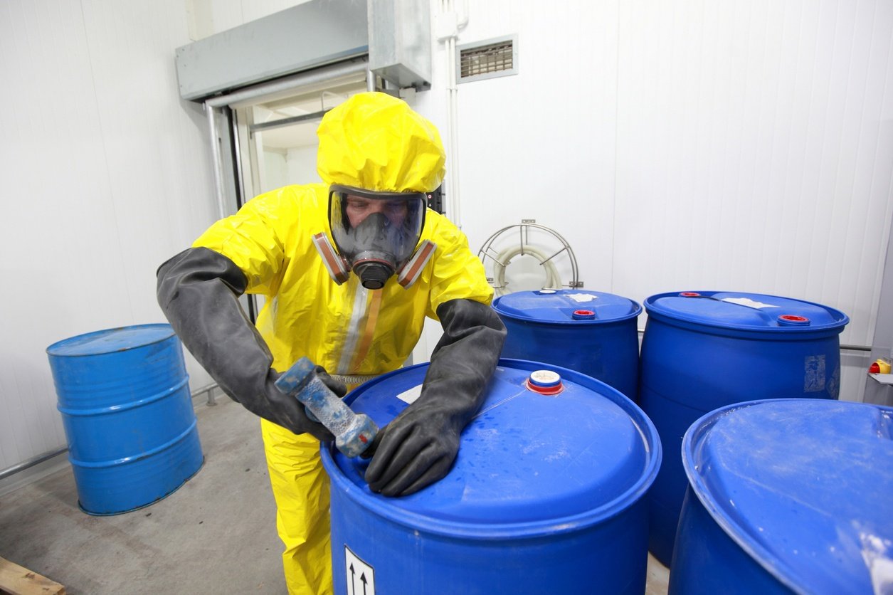Man-Closing-Hazardous-Waste-Container
