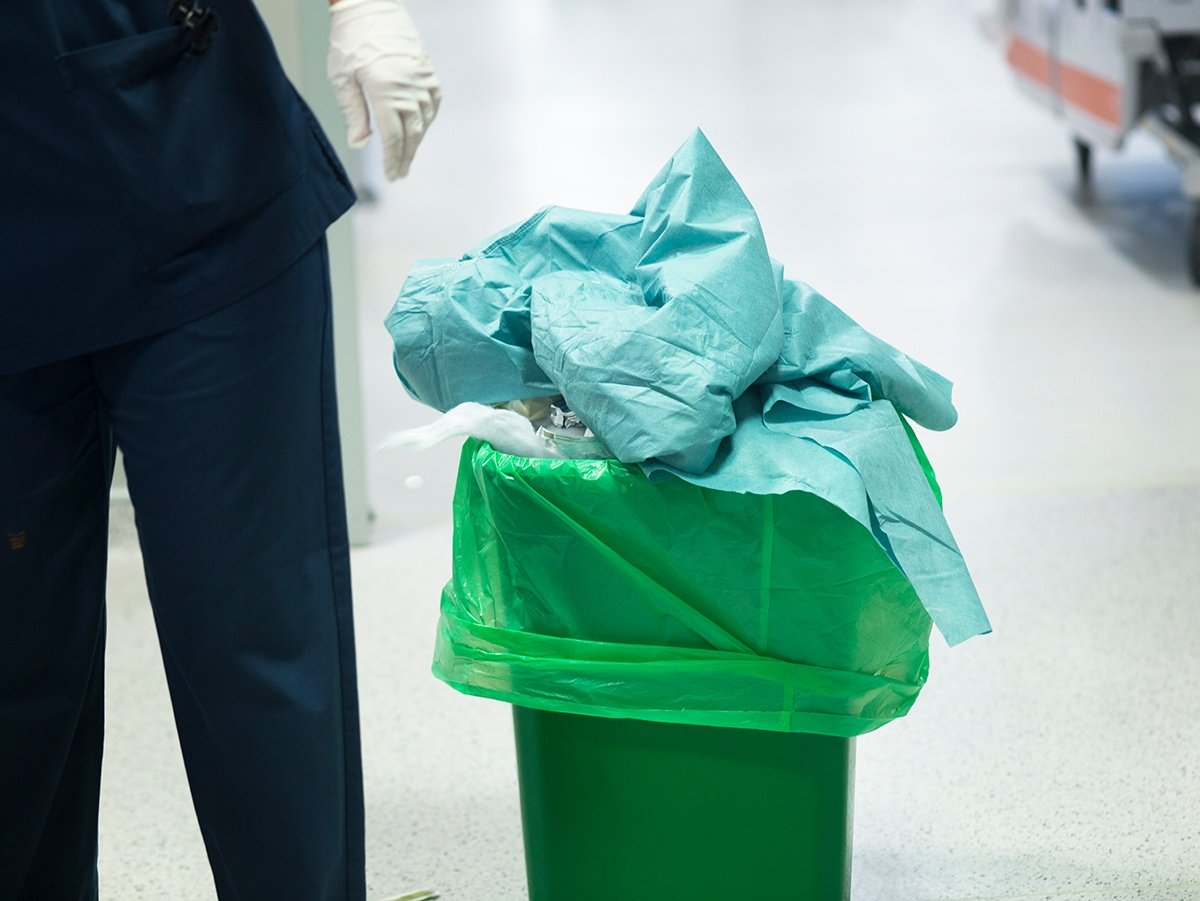 Man-Putting-Medical-Waste-in-Wrong-Bin